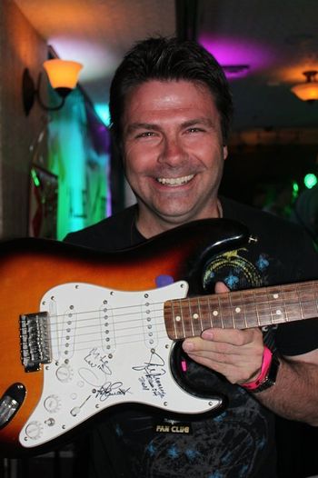 David (guitars) was beaming after the members of Triumph signed his Fender Strat in June 2011
