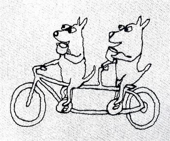Two dogs drinking coffee riding a tandem
