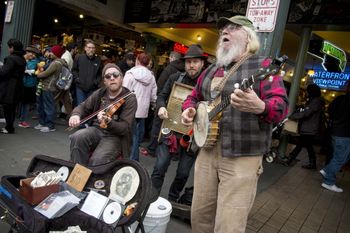 Three of the best, undated. The banjo player is a seasonal logger up in Maine. From http://www.ieyenews.com/wordpress/pike-place-market/
