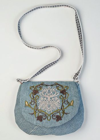 Eleven Court Tree Crest embroidered on upcycled denim. The strap is a belt.

