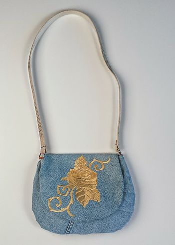Baroque Punk Rose embroidered on upcycled denim. The strap is a belt.
