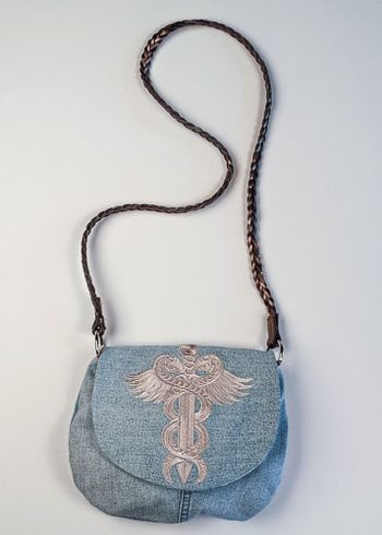 Baroque Punk Snakes and Dagger embroidered on upcycled denim. The strap is a belt.
