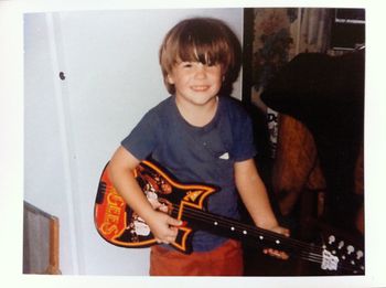 Not quite 5 years old. The Bee Gees plastic guitar. Yeah, I always knew... Look, I'm even holding the pick properly!
