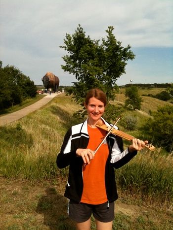 Julane plays her pocket fiddle in Jamestown, North Dakota in front of the world's largest buffalo!
