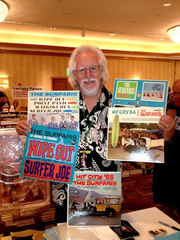 Bob holding a collection of original vinyl albums at The Hollywood Show

