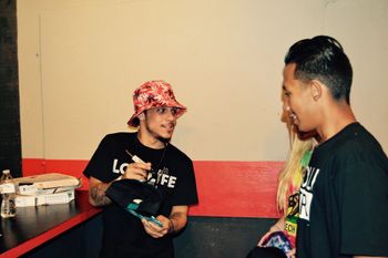 SwizZy B signing autographs at Afroman concert
