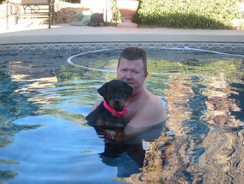 Phantom Wood Infamous Chili Palmer relaxing in the pool with his owner, Kevin Lane.
