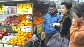 Our interpreter walking by a colorful fruit stand. She was amazing, she took care of all the details of our trip to Korea.
