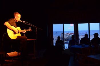 Live at the Cafe Echouerie in Natashquan, home of the legendary Quebec songwriter Gilles Vigneault. Bruno Simard was there on a vacation and took his amazing shot, showing just how close this venue is  to the Atlantic Ocean.
