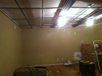 Drop ceiling grid and fake beams installed
