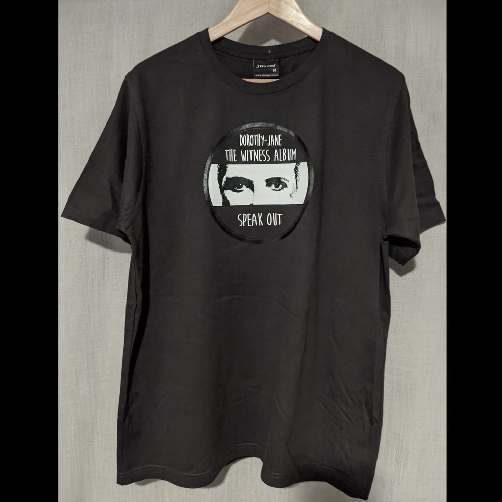 All cotton quality t-shirt. No sweat shops! Colour: dark grey. Artwork printed on front: Dorothy-Jane - The Witness - SPEAK OUT 