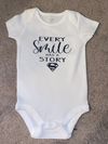 Every Smile has a Story Superman Onesie