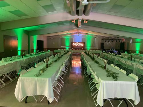 Green Uplighting at Wedding Reception from Musical Genius Productions With Four Rows of Tables