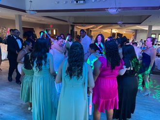 wedding guests dancing in circle with glow sticks