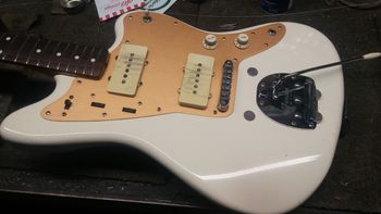 George Tomsco's ( the Fireballs band ) Japanese re-issue white  Fender Jazzmaster after I converted it to a gold anodized aluminum pickguard to more closely resemble his original 1958 guitar.
