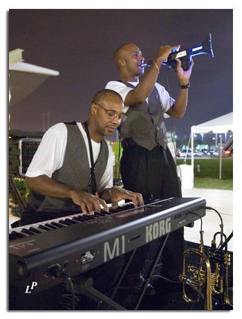 Twin Connection performing at the Sugar Land Town Square                                                                                   Derwin on keyboard, and Darwin playing the digital trumpet.
