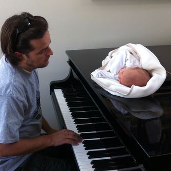 Paul playing piano for his daughter
