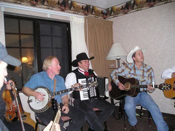 2006 - Our favorite part of the RMFA Convention are the nightly jams
with our fellow musicians. The jams would never happen
without our buddy John Dunnigan (on the banjo), who puts in
an enormous amount of time and effort on everyone's behalf.
You never know what's going to happen or who's going to stop
by. How cool to have Ty England and his very talented band
