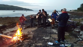 Tunes around the fire at Rum
