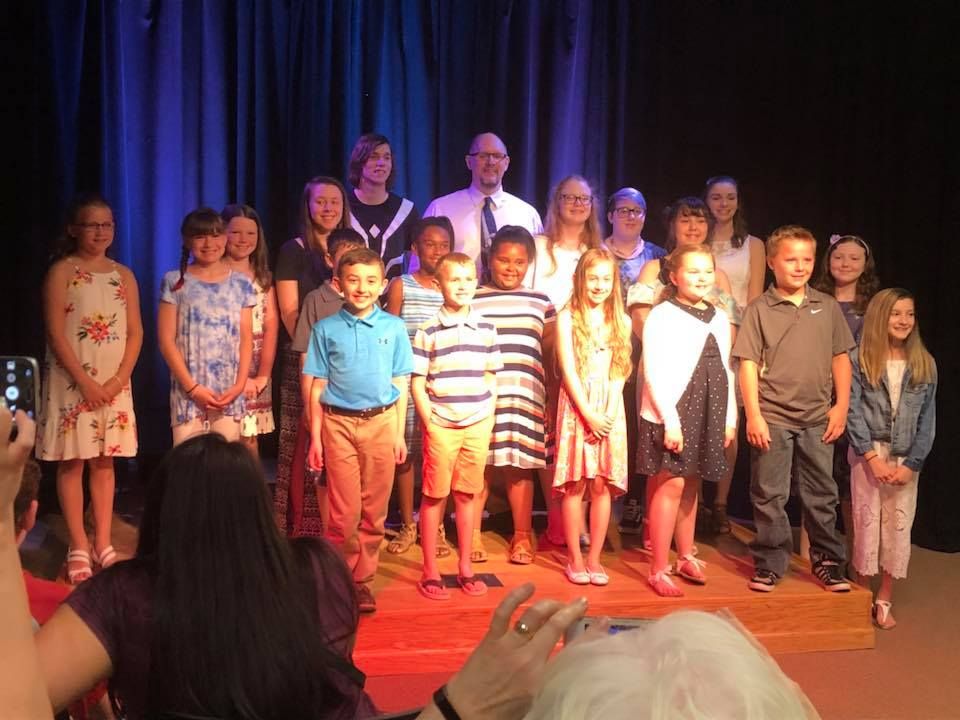 Students with Shawn after a piano recital.