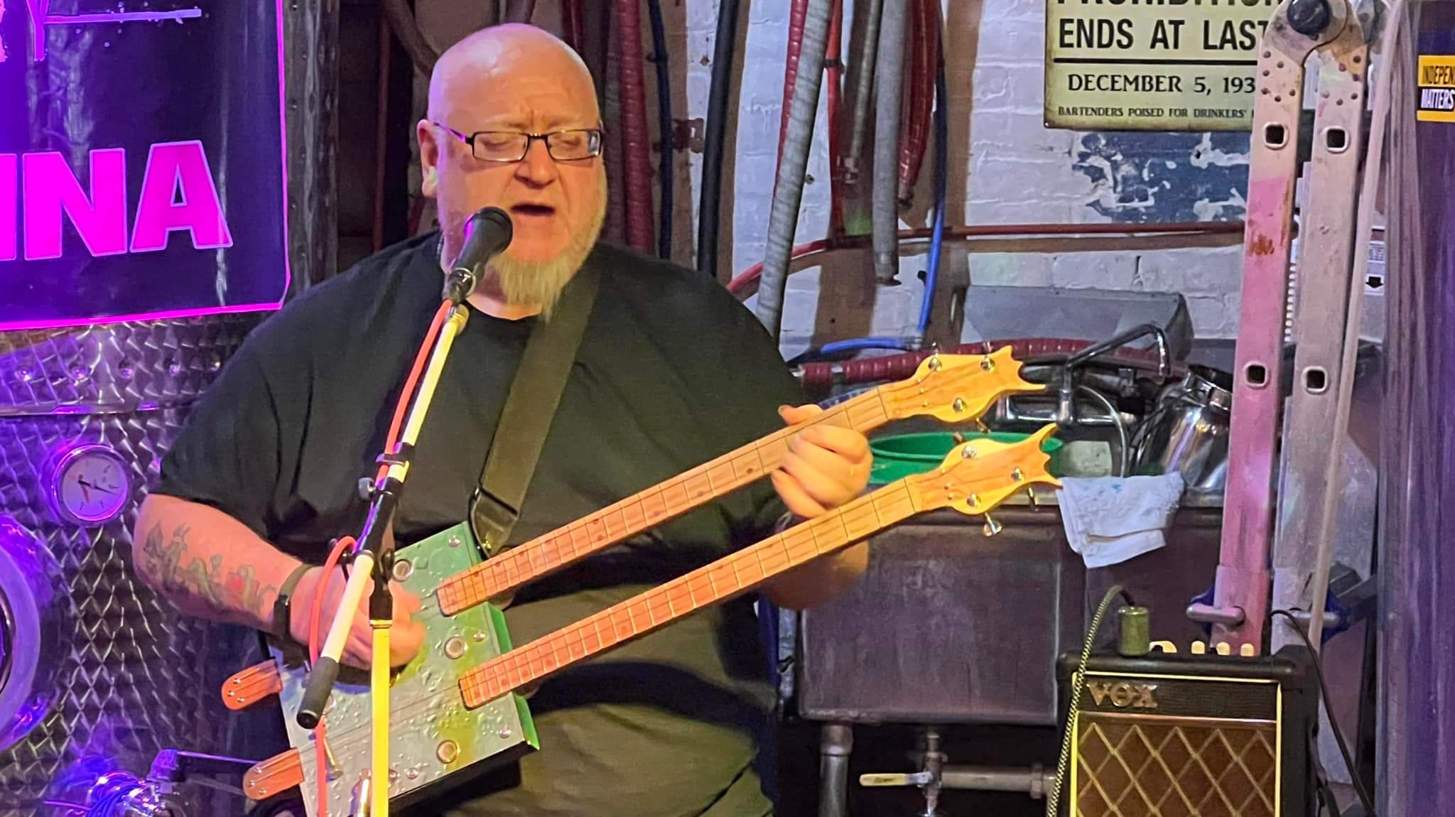 Max B. Greene playing a double necked cigar box guitars