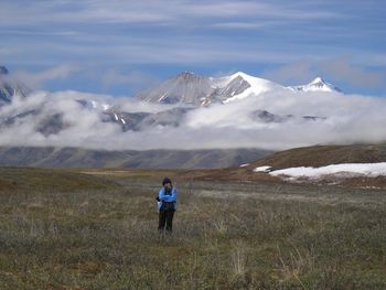 Kathryn, summer solstice in the Okpilak River valley on the North Slope of the Brooks Range. Mt. Michelson and the Romanzof Mountains in the background.
