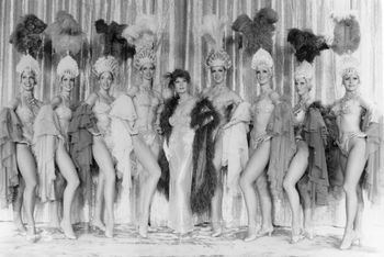 Ann Corio with the cast of This Was Burlesque. The silver gown was displayed in the exhibit.
