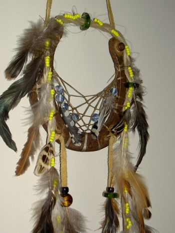 Close-up of Gem's dream catcher. She is a white horse with a white tail.
