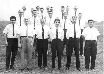 Kenton Clinics Faculty, ca. 1964 front row: Marvin Stamm, Johnny Richards, Chubby Jackson, Ray Santisi, last 2 unk. middle row: John LaPorta, Leon Breeden, Clem DeRosa, last 2 unk. rear: Stan Kenton, unk, unk, Charlie Mariano, Dee Barton, unk, Herb Pomeroy, unk, Matt Benton.
