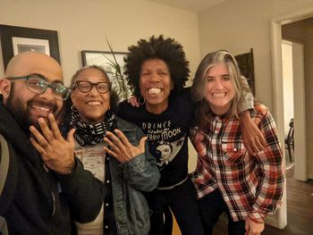 Anand and three members of Skip the Needle (Vicki, Kofy, and Katie) pose for a group photo in Kofy's living room in November 2021.
