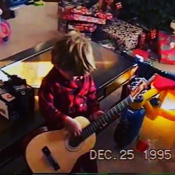 Alex and his first guitar, age 2.
