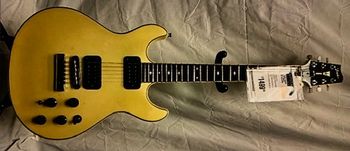 1984 white Fender Esprit Elite that's morphed into a golden yellow over time.
