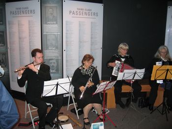 Performing on flute in the docks of Liverpool, Mark Jones participating with members of a.P.A.t.T. Orchestra
