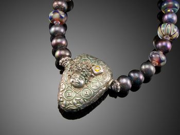 Fairy Dust - Fine silver hollow form textured bead pendant. Layered with other silver elements . Necklace is peacock blue pearls and lampwork beads.McKenzie's Jewelry by Nancy Koehler