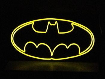 Batman This wall hanging features the classic Batman symbol in colored, lighted wire (EL wire) on top of a 12" high x 24" wide x 1/16" thick black, diamond tread plate.
