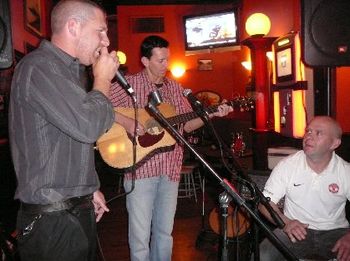 Ruari comes out from behind the bar to sing a little song with Pat and Collie.
