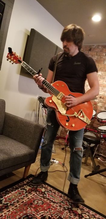 Marc Muir laying an electric guitar track.
