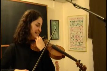 Maria tuning her fiddle
