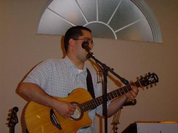 Tim Beckman Singing and Playing Acoustic Lead in Gospel Concert in Church. Tim Also Sings Harmony on Stage and Sang on Several Selections on "The Father & Son" Project.