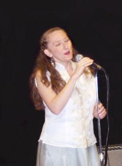 Singing a ballad during a concert at the APE Gallery, Northampton, MA.
