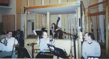 Mary Ann, always working.  Trombones, always laughing.  L to R:  Mike Christianson, Mark Patterson, Mary Ann McSweeney, Pete McGuinness, 3/25/03.
