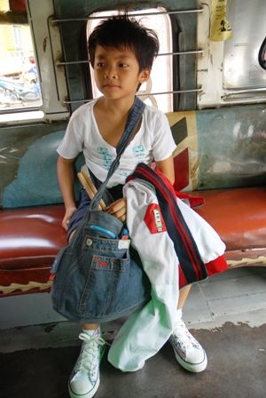 My little brother Panhlauv with his many bags in a jeepney
