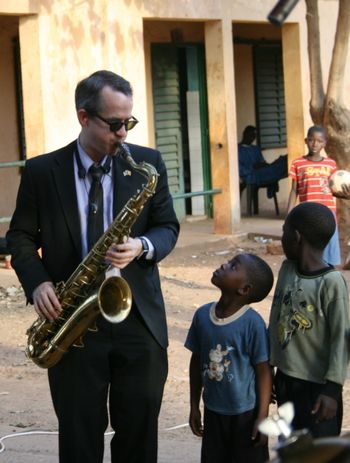 Chris Byars, Cultural Envoy 6 playing for an interested youngster at the School for the Blind in Bamako, Mali.
