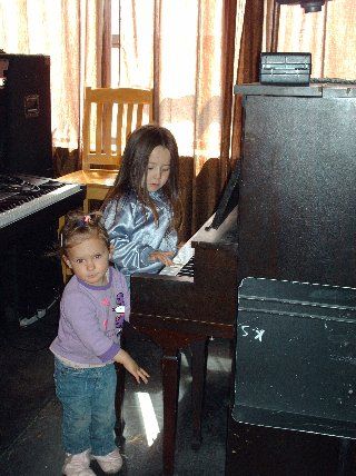 My 2nd oldest on piano, with accompaniment by our friend Ava
