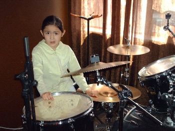 My oldest daughter playing with the drum kit. ahhh, a studio child....
