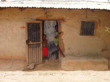 Two Children in the doorway in Mandinari, Daniel's home village from childhood
