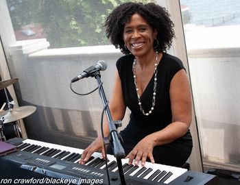 Smiling_at_the_piano_color_Photo_Credit_Ron_Crawford
