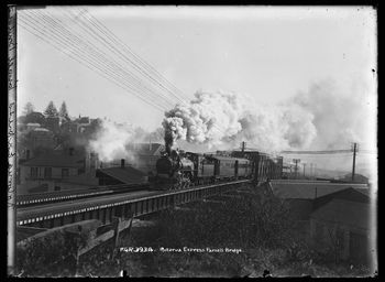 Showing the Rotorua Express steam train on the Parnell railway bridge as it leaves Auckland 1920
