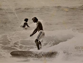 Beautifully tanned Greg Alach on one of the newer slimmer boards we were riding in '67 Brian King in the background....Waipu ...summer of '67
