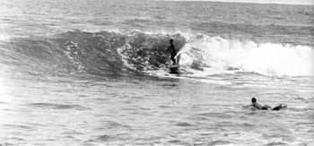 Kevin Lewis, Des Atkins paddling out - Point Annihilation Mahia, February '66
